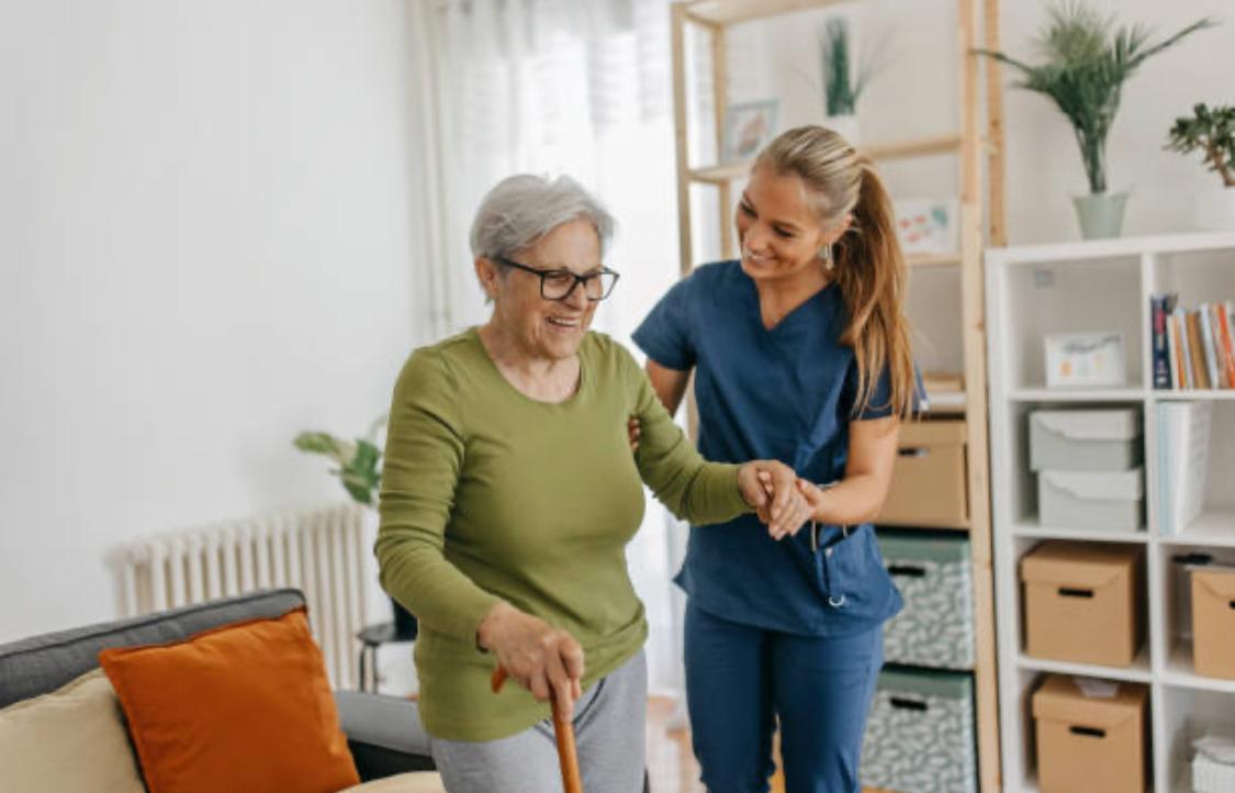 Caregiver helping senior with mobility support